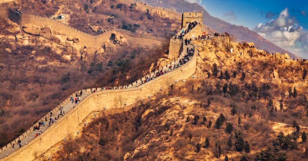 The majestic Great Wall of China stretches across picturesque mountains, drawing in global tourists.